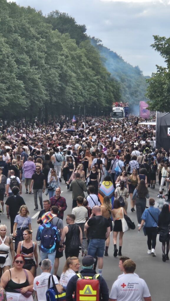 Crowds celebrating Berlin Pride with floats and thousands of people dancing in the streets during the CSD parade in Berlin