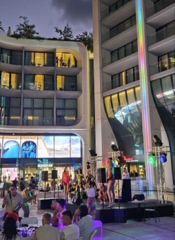 Drag queens hosting a bingo game at a square during a Malta Pride event.