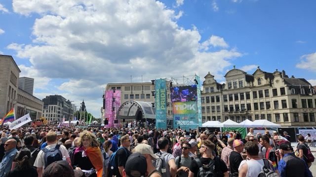People lining the street at Brussels Gay Pride parade, celebrating LGBTQ+ rights and visibility in Belgium.