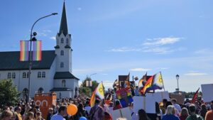 Reykjavik Pride Parade (Hinsegin dagar) with people celebrating LGBTQ+ equality along a main street in Iceland's capital.