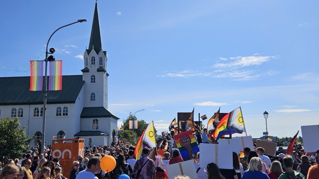 Reykjavik Pride Parade (Hinsegin dagar) with people celebrating LGBTQ+ equality along a main street in Iceland's capital.