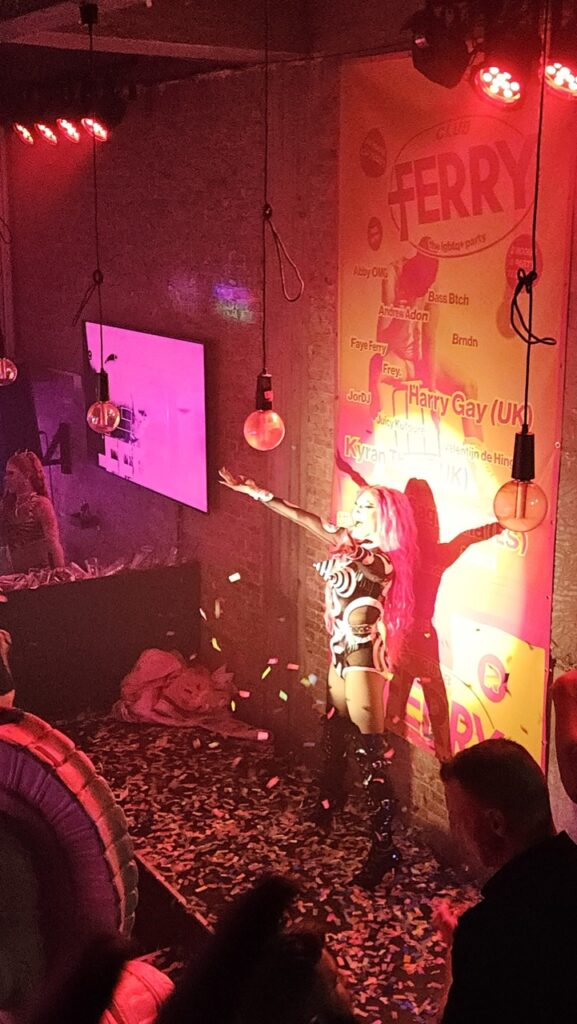Drag performance at an afterparty in Club Ferry, with people enjoying a live LGBTQ+ show.