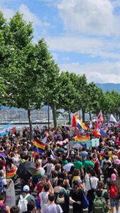 Crowd attending Geneva Pride, with people celebrating LGBTQ+ pride in the city.