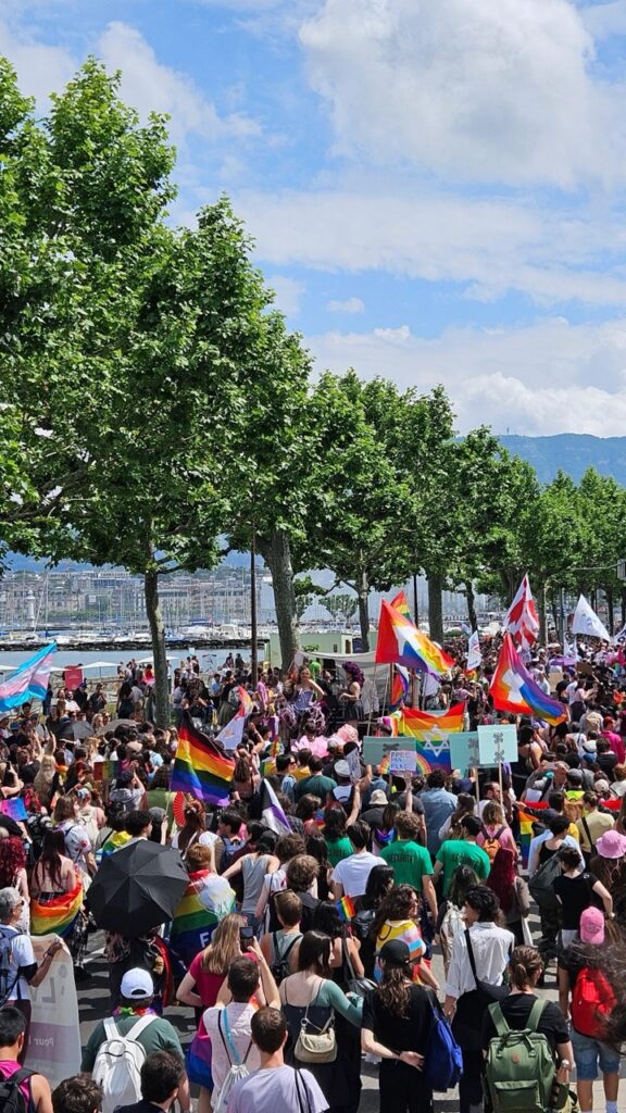 Crowd attending Geneva Pride, with people celebrating LGBTQ+ pride in the city.