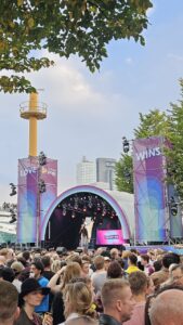Crowd celebrating Rotterdam Pride festival at Willemsplein, with people enjoying LGBTQ+ events in the city.