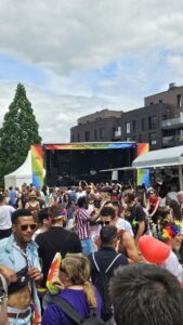Crowd gathered at the village stage during Luxembourg Pride, enjoying a live concert and celebrating LGBTQ+ pride.