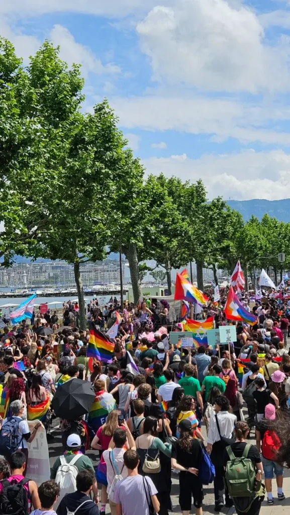Geneva Pride march with rainbow flags and LGBTQ+ participants in the streets of Geneva, Switzerland