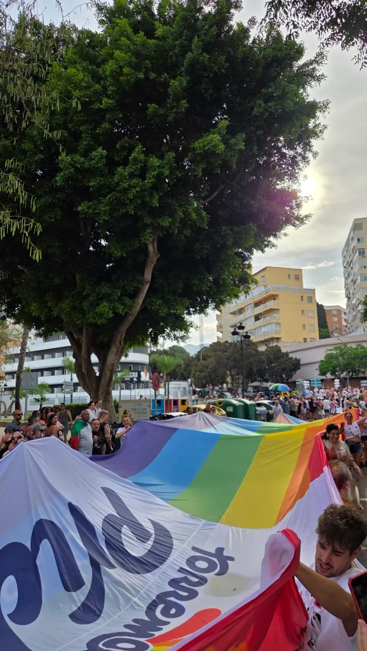 Torremolinos Pride parade with rainbow flags and thousands of people celebrating on the Costa del Sol