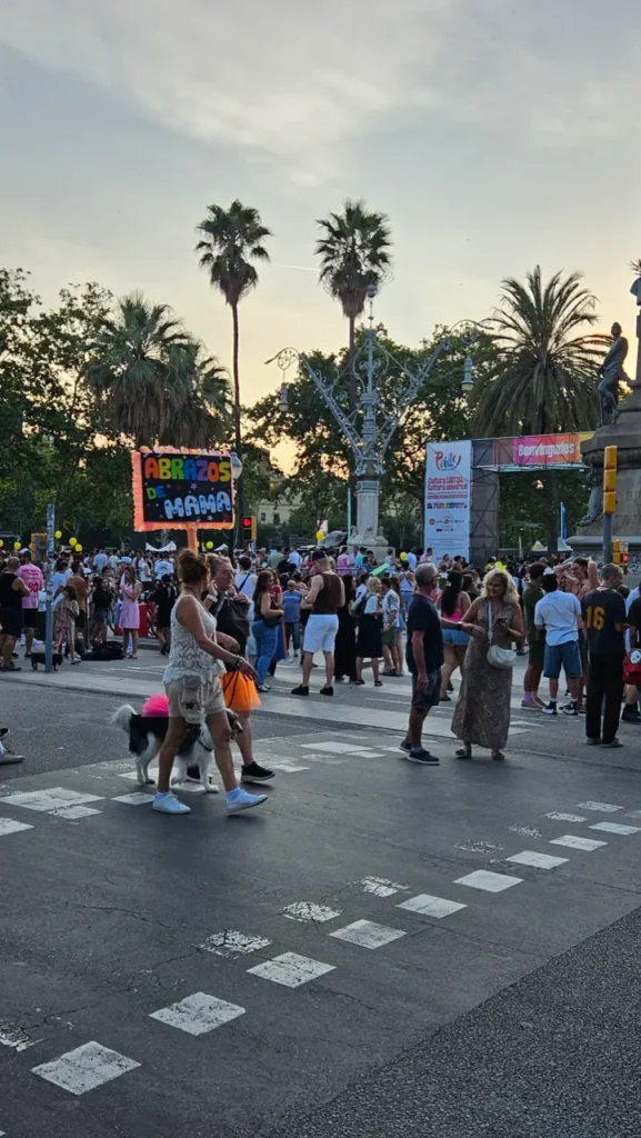 Participants celebrating Barcelona Pride with rainbow flags during the parade through the streets of Barcelona, Spain.
